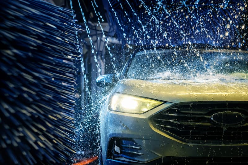 Water and foam on car surface with clean finish